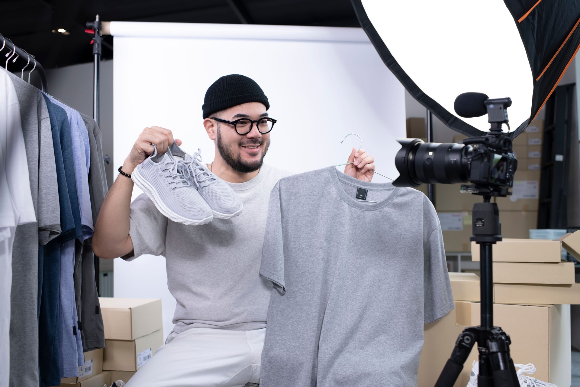 Asian man blogger or vlogger looking at camera reviewing product.